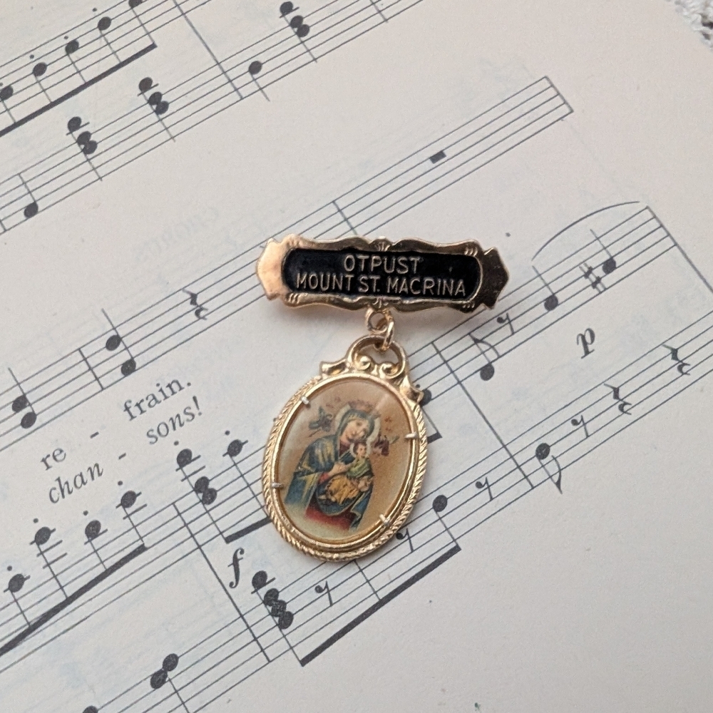 Gold and Black Religious Brooch